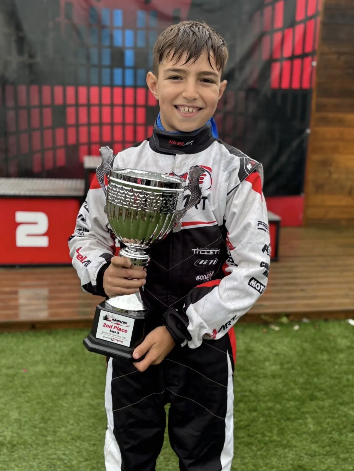 Damian holding his second place trophy at Hamilton
